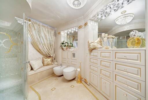 Lidia Bersani / Luxury Interior - Luxury Classical Bathroom, ceam color marble, with gold mosaic. Furniture  in cream color with gold finish. Crystals lamps and round gold decoration shower with heated bench 
