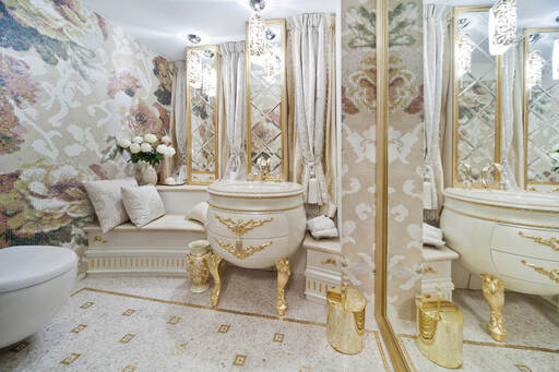 Lidia Bersani / Luxury Interior - Beautiful geust toillet with vanity ivory and gold finishing, floral mosaic on the walls, and gold mosaic of the floor, silk curtains  between mirrors 