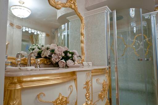 Lidia Bersani / Luxury Interior - Bathroom with golden sink cabinet, with marble top and double taps with Swarovski crystals
