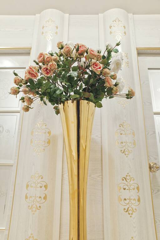 Lidia Bersani / Luxury Interior - Golden high vase among white color pilasters with golden pattern 